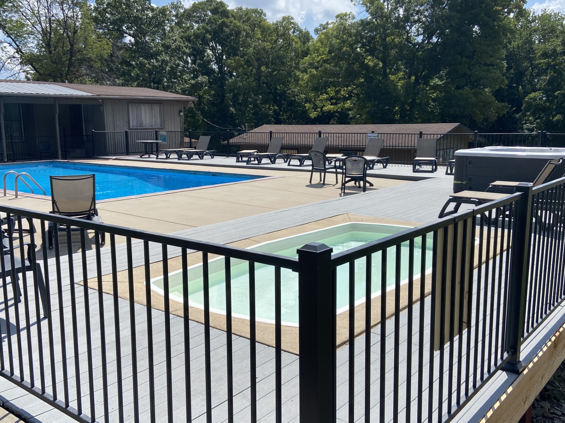 Resort pool with lounge chairs and hot tub