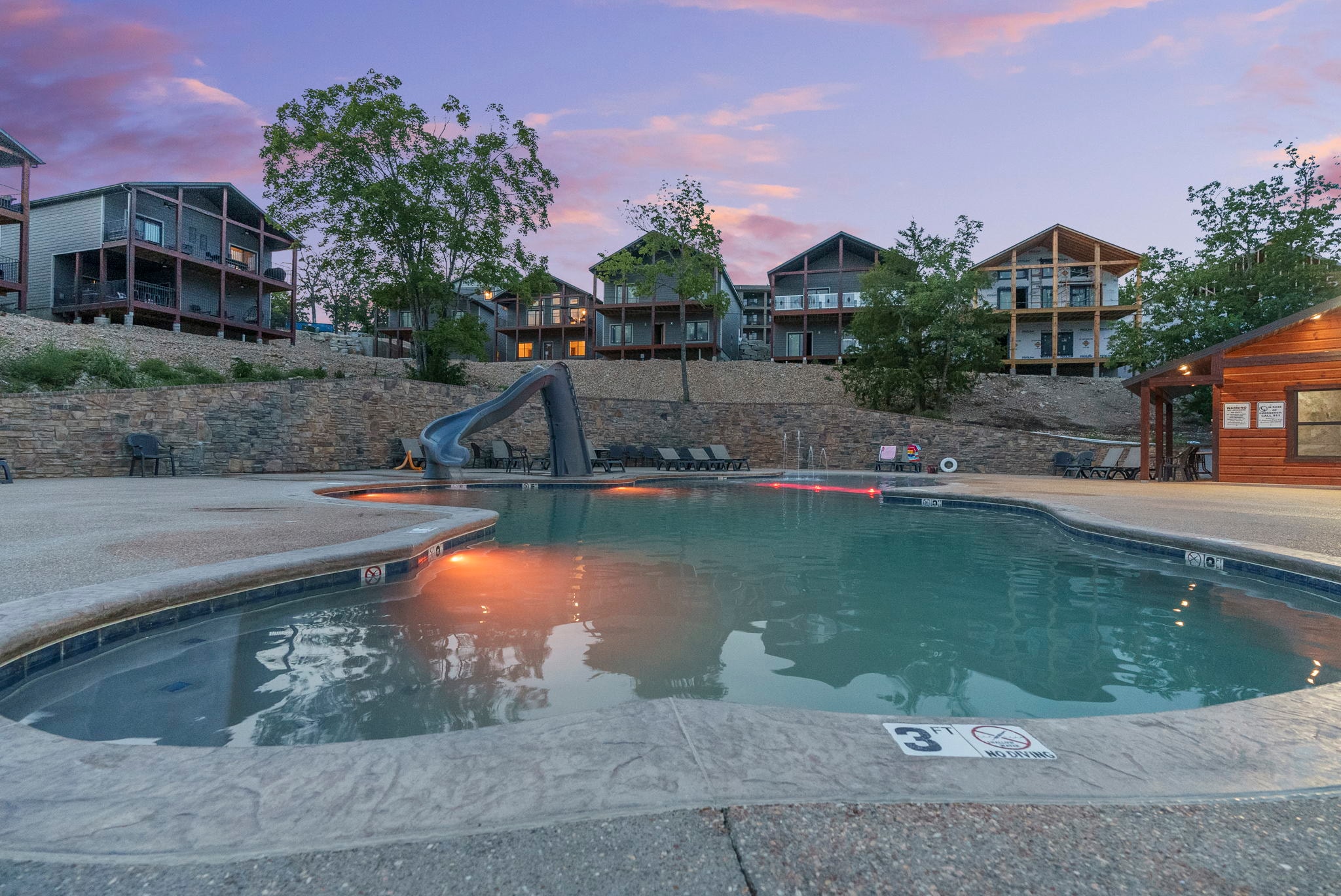 Resort pool and waterslide at dusk