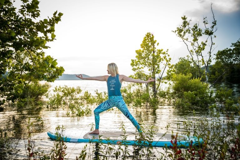 Woman practicing yoga on a paddleboard on Table Rock Lake