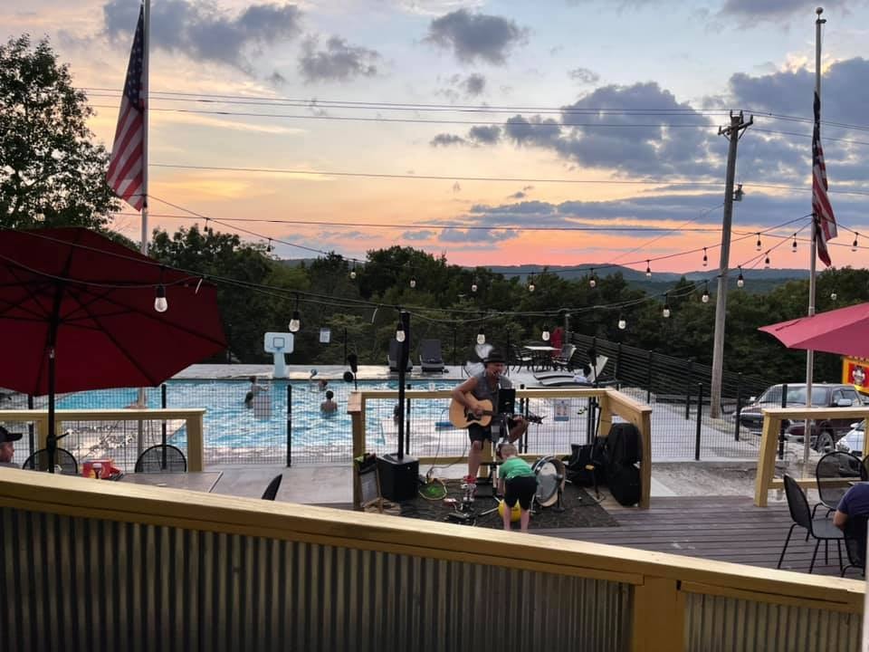 Shady Taco outdoor patio with pool and live music at sunset