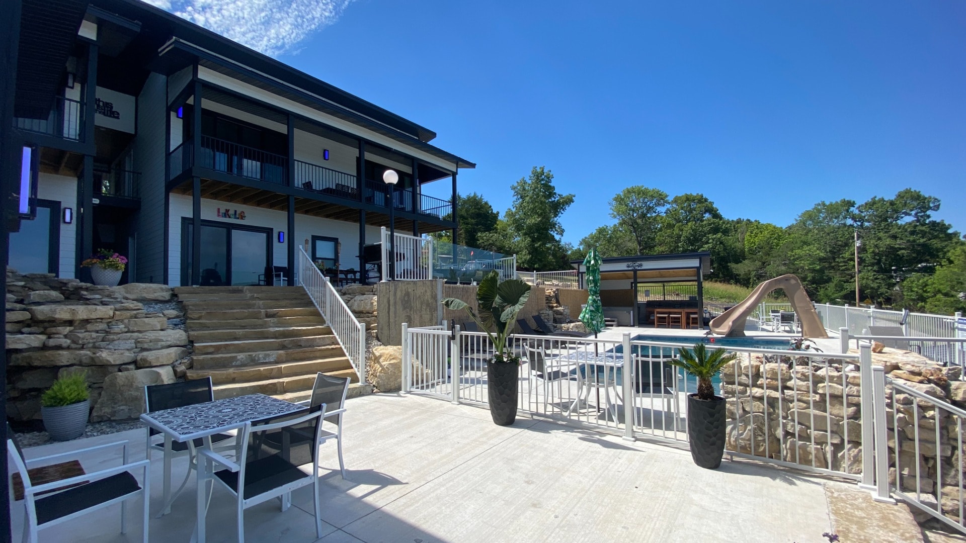 Resort pool with waterslide and patio seating